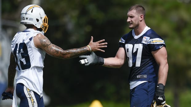 Jul 25, 2019; Costa Mesa, CA, USA; Los Angeles Chargers defensive end Joey Bosa (97) meets with wide receiver Keenan Allen (13) during training camp at Jack Hammett Sports Complex. Mandatory Credit: Kelvin Kuo-USA TODAY Sports  